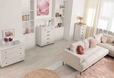 Photo of Cozy living room interior. Side table, sofa and shelving unit indoors, above view