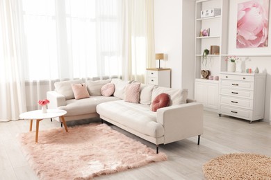 Photo of Cozy living room interior. Side table, sofa and shelving unit indoors