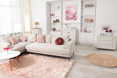 Photo of Cozy living room interior. Side table, sofa and shelving unit indoors