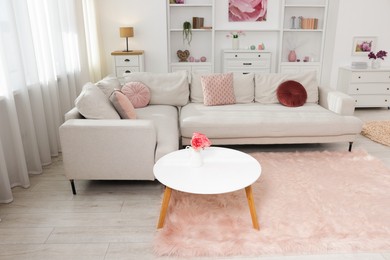 Photo of Cozy living room interior. Side table, sofa and shelving unit indoors