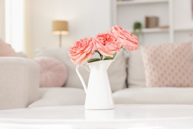 Photo of Vase with beautiful flowers on white table indoors, closeup