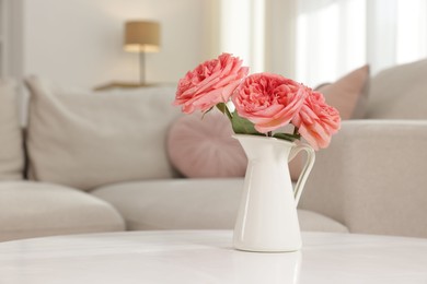 Photo of Vase with beautiful flowers on white table indoors, closeup