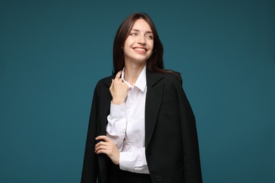 Photo of Happy woman in suit on light blue background
