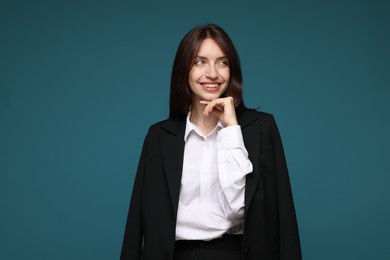 Photo of Happy woman in suit on light blue background