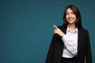 Photo of Happy woman in suit on light blue background, space for text