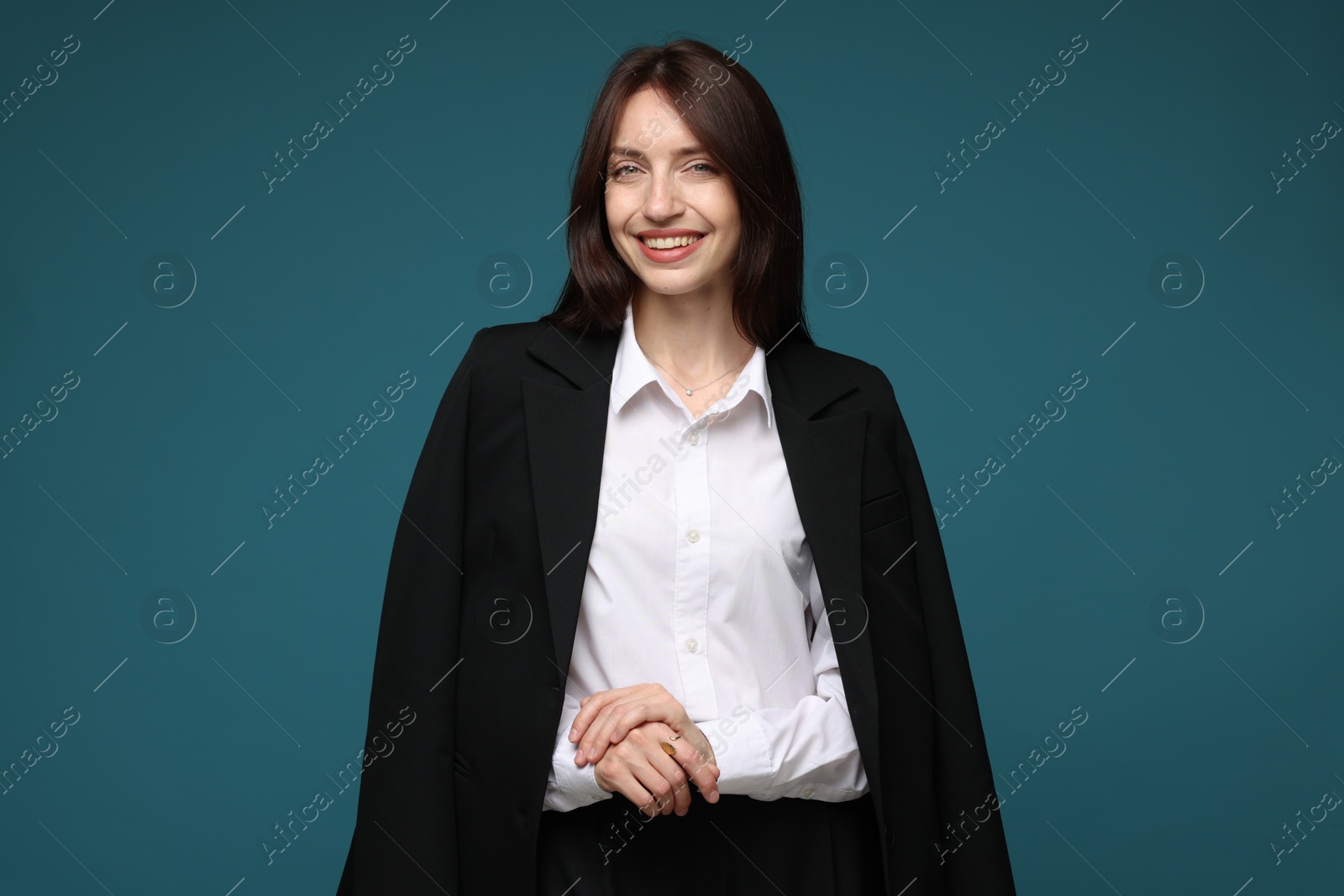 Photo of Happy woman in suit on light blue background