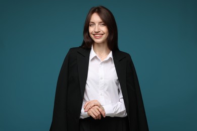 Photo of Happy woman in suit on light blue background