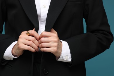 Photo of Woman in suit on light blue background, closeup