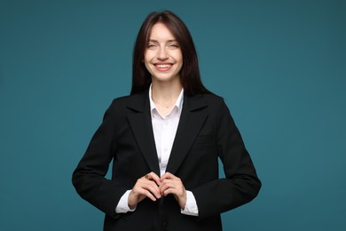 Photo of Happy woman in suit on light blue background