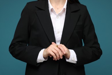 Photo of Woman in suit on light blue background, closeup