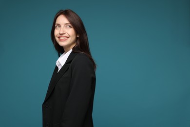 Photo of Happy woman in suit on light blue background, space for text