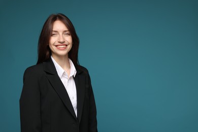 Photo of Happy woman in suit on light blue background, space for text