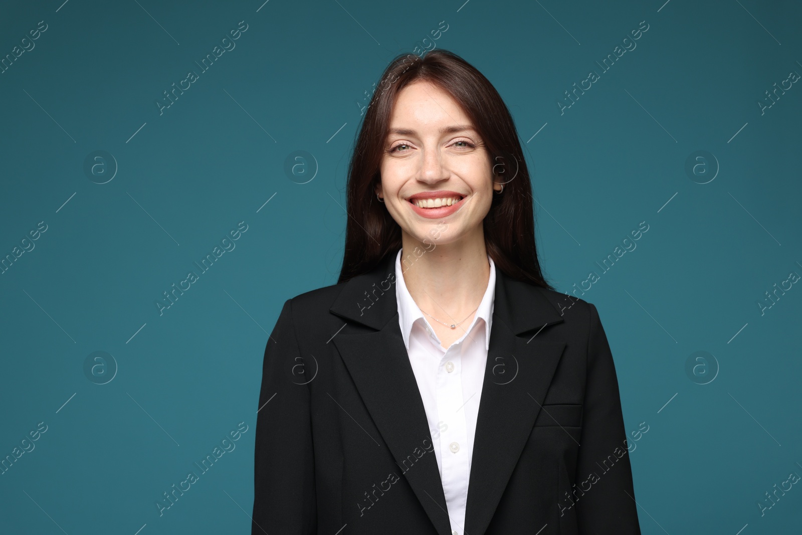 Photo of Happy woman in suit on light blue background