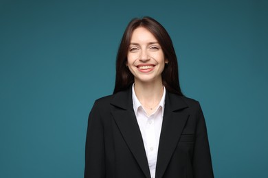 Photo of Happy woman in suit on light blue background