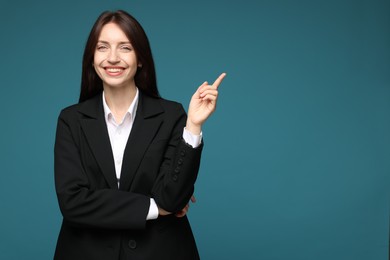 Photo of Happy woman in suit on light blue background, space for text