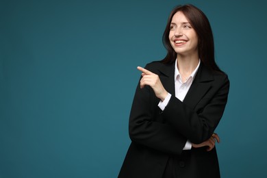 Photo of Happy woman in suit on light blue background, space for text