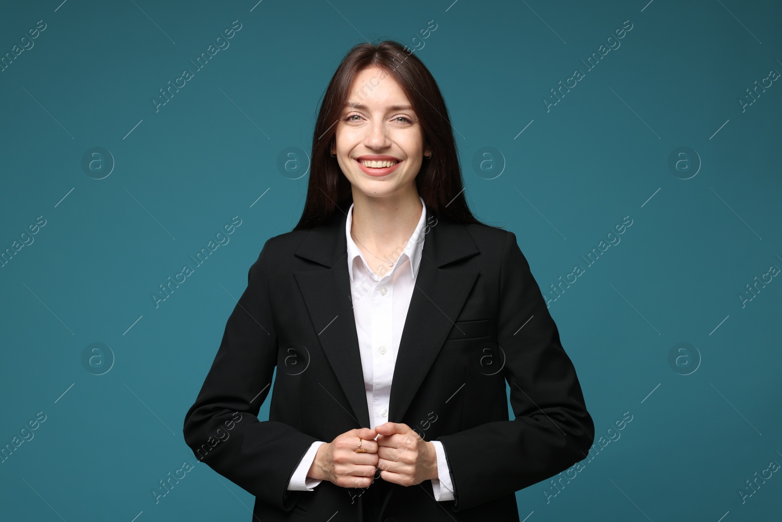 Photo of Happy woman in suit on light blue background