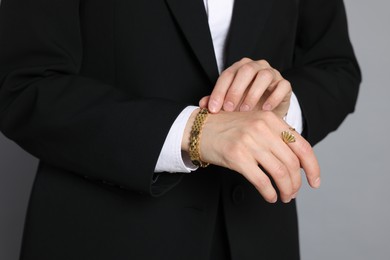 Photo of Woman in suit on grey background, closeup