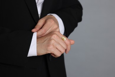 Photo of Woman in suit on grey background, closeup. Space for text