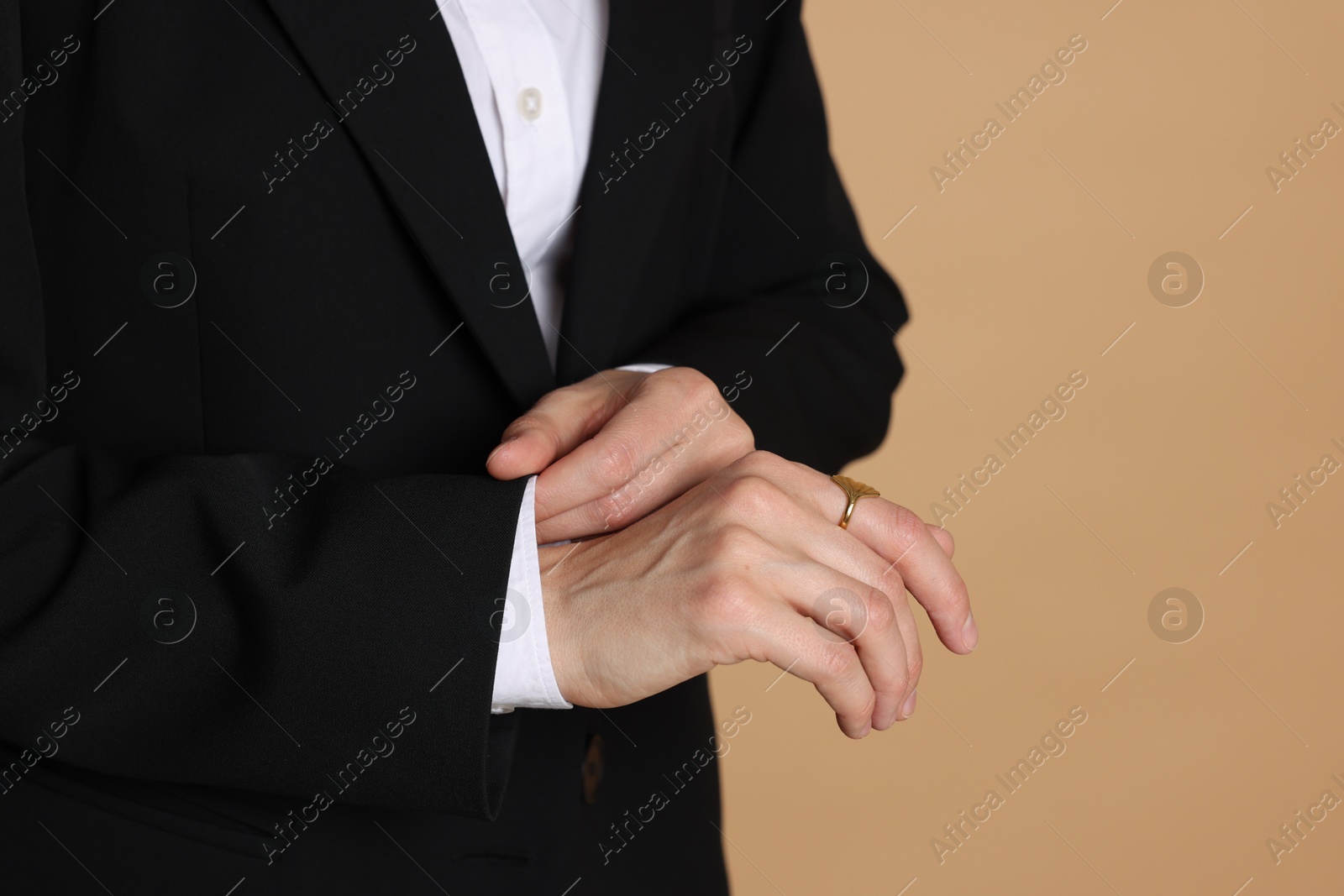 Woman in suit on beige background, closeup. Space for text Photo of Woman in suit on beige background, closeup. Space for text
