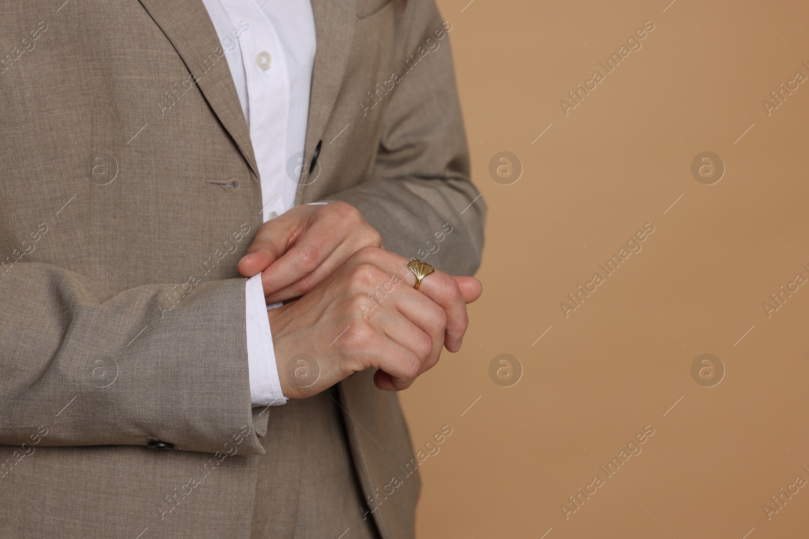 Woman in suit on beige background, closeup. Space for text Photo of Woman in suit on beige background, closeup. Space for text