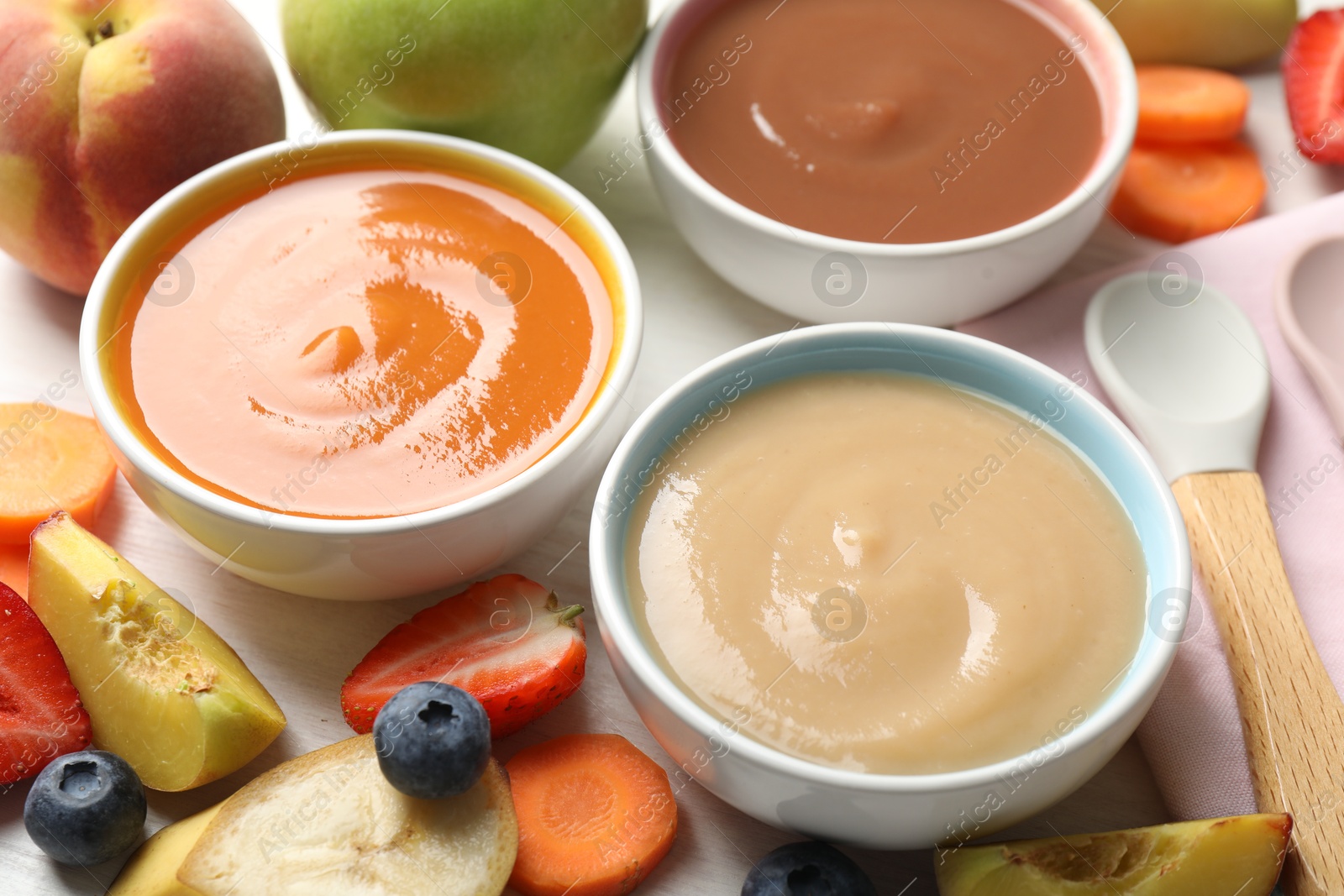 Baby food. Tasty puree in bowls and different ingredients on table, above view Photo of Baby food. Tasty puree in bowls and different ingredients on table, above view