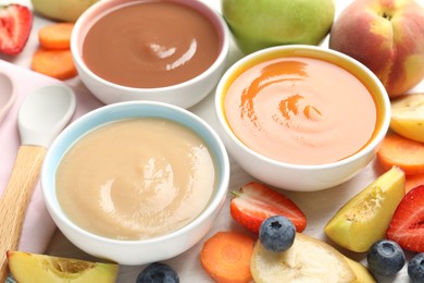 Photo of Baby food. Tasty puree in bowls and different ingredients on table, above view