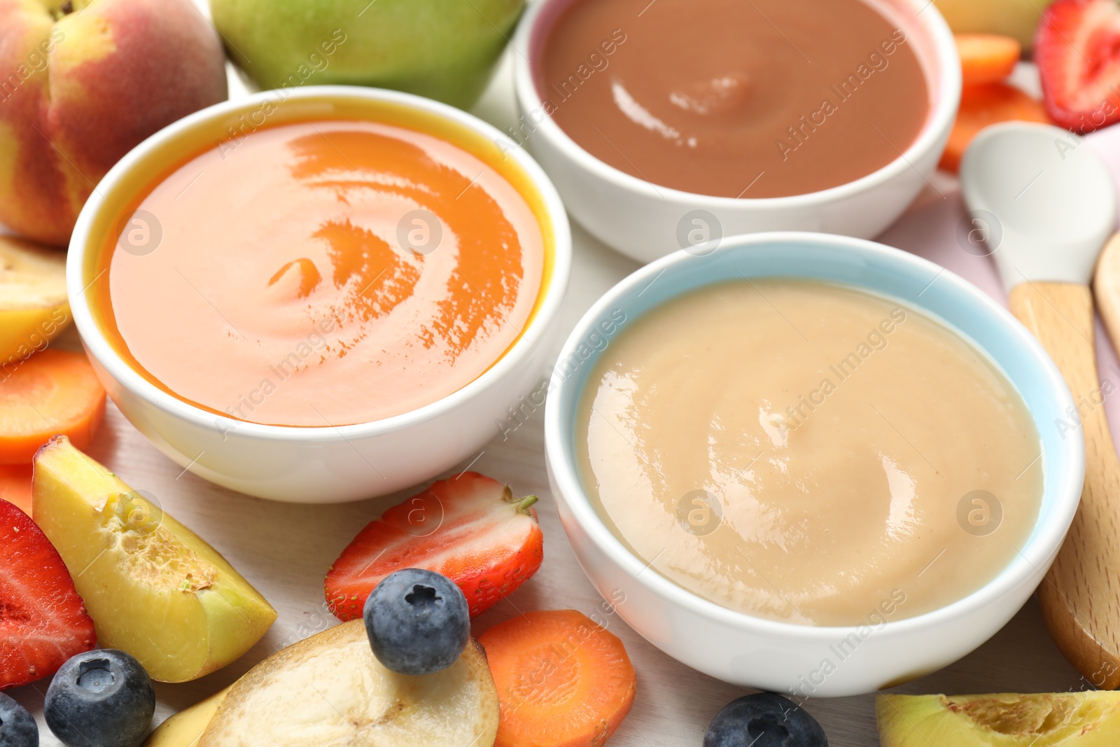 Baby food. Tasty puree in bowls and different ingredients on table, above view Photo of Baby food. Tasty puree in bowls and different ingredients on table, above view