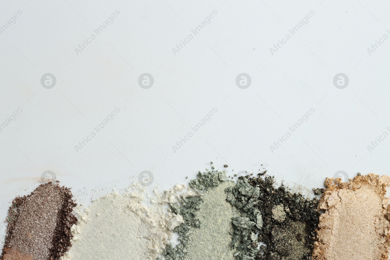 Colorful eyeshadows on white background, flat lay. Space for text Photo of Colorful eyeshadows on white background, flat lay. Space for text