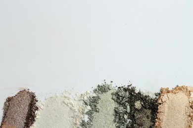 Photo of Colorful eyeshadows on white background, flat lay. Space for text
