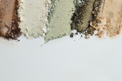 Photo of Colorful eyeshadows on white background, flat lay. Space for text