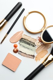 Photo of Different cosmetic products, makeup brushes and mirror on white background, flat lay