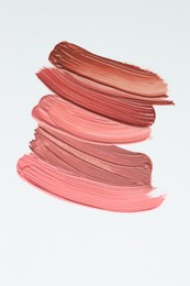 Photo of Colorful lip glosses on white background, flat lay