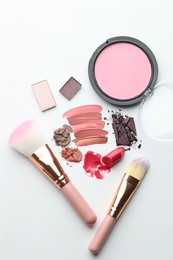 Photo of Different cosmetic products and makeup brushes on white background, flat lay