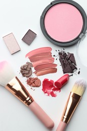 Photo of Different cosmetic products and makeup brushes on white background, flat lay