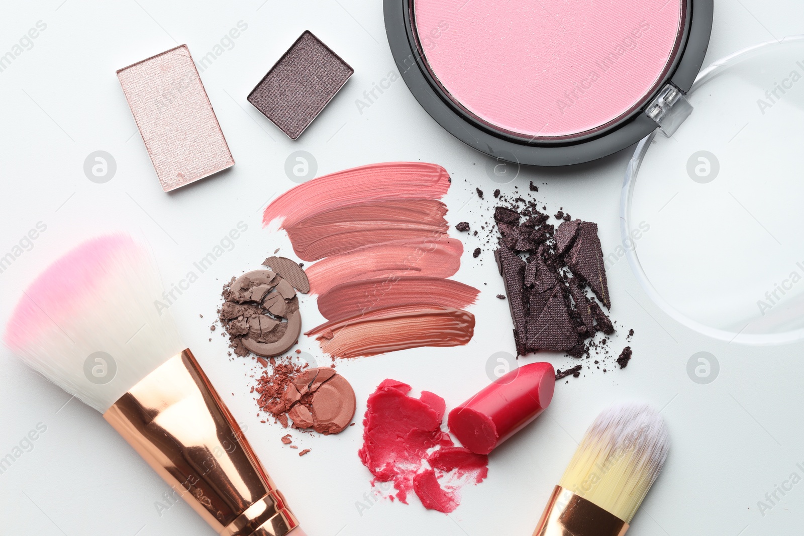 Photo of Different cosmetic products and makeup brushes on white background, flat lay