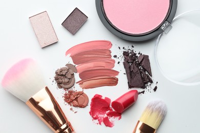 Photo of Different cosmetic products and makeup brushes on white background, flat lay