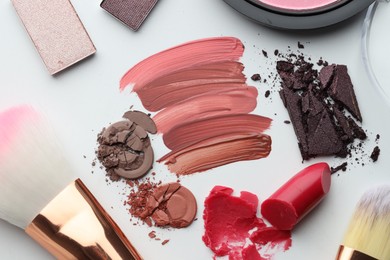Photo of Different cosmetic products and makeup brushes on white background, flat lay