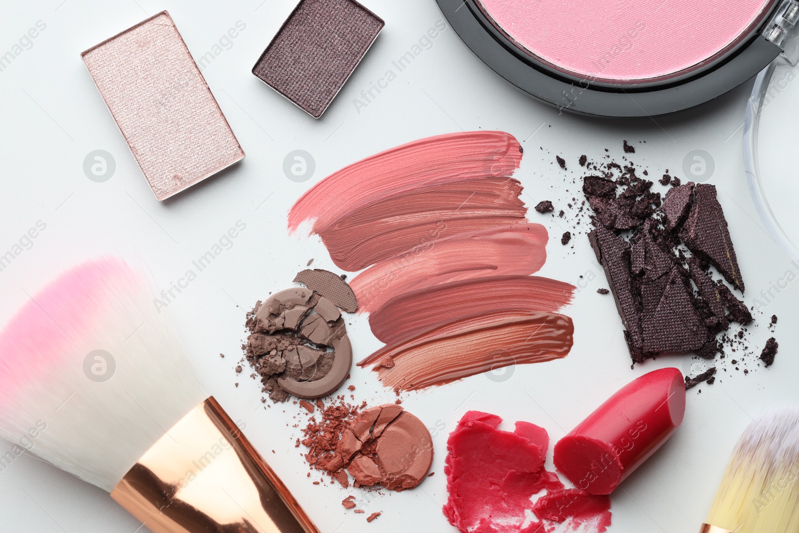 Photo of Different cosmetic products and makeup brushes on white background, flat lay