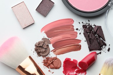 Photo of Different cosmetic products and makeup brushes on white background, flat lay