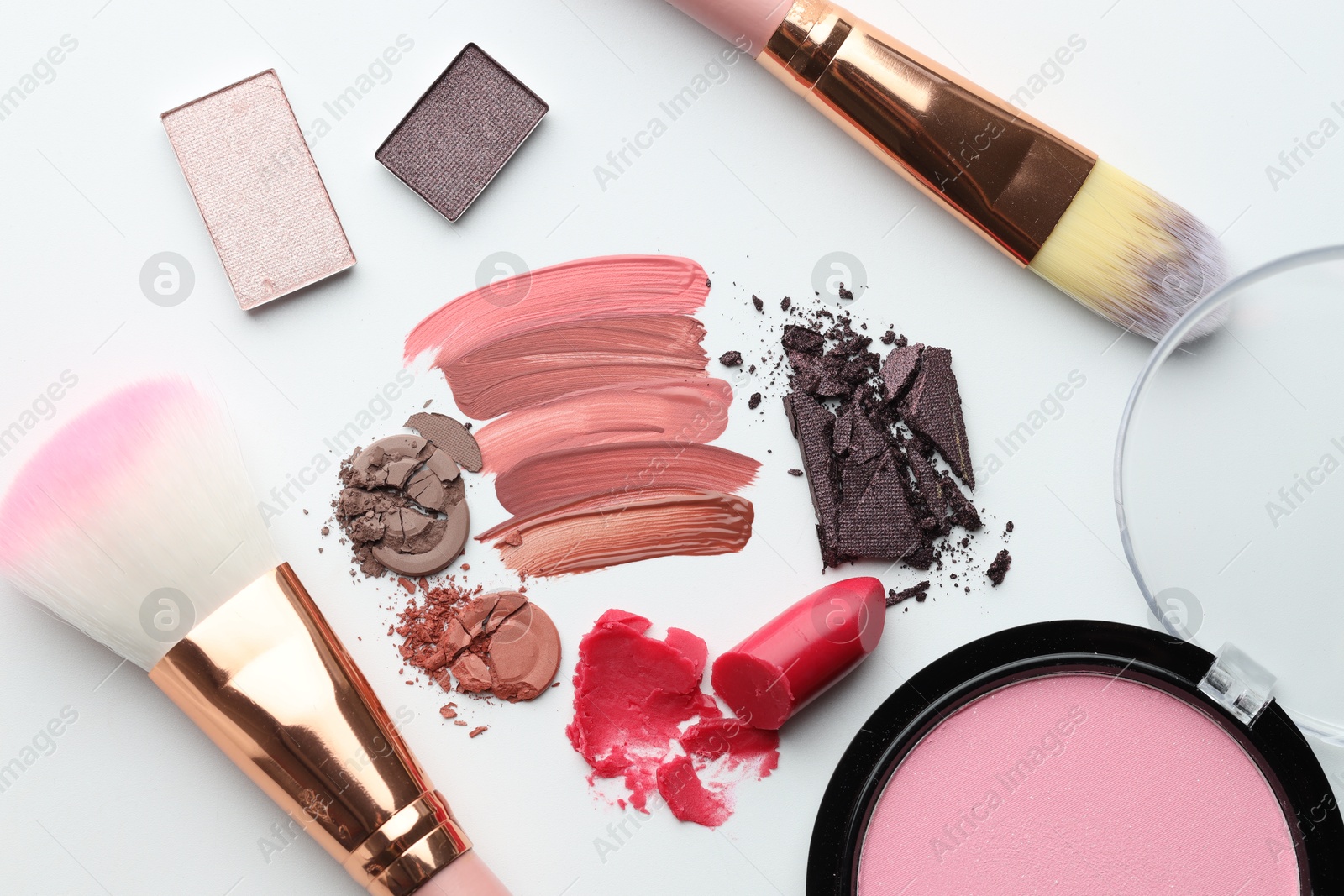 Different cosmetic products and makeup brushes on white background, flat lay Photo of Different cosmetic products and makeup brushes on white background, flat lay