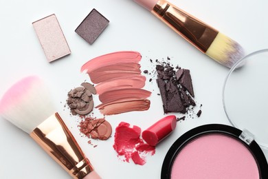 Photo of Different cosmetic products and makeup brushes on white background, flat lay