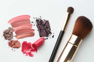 Photo of Different cosmetic products and makeup brushes on white background, flat lay