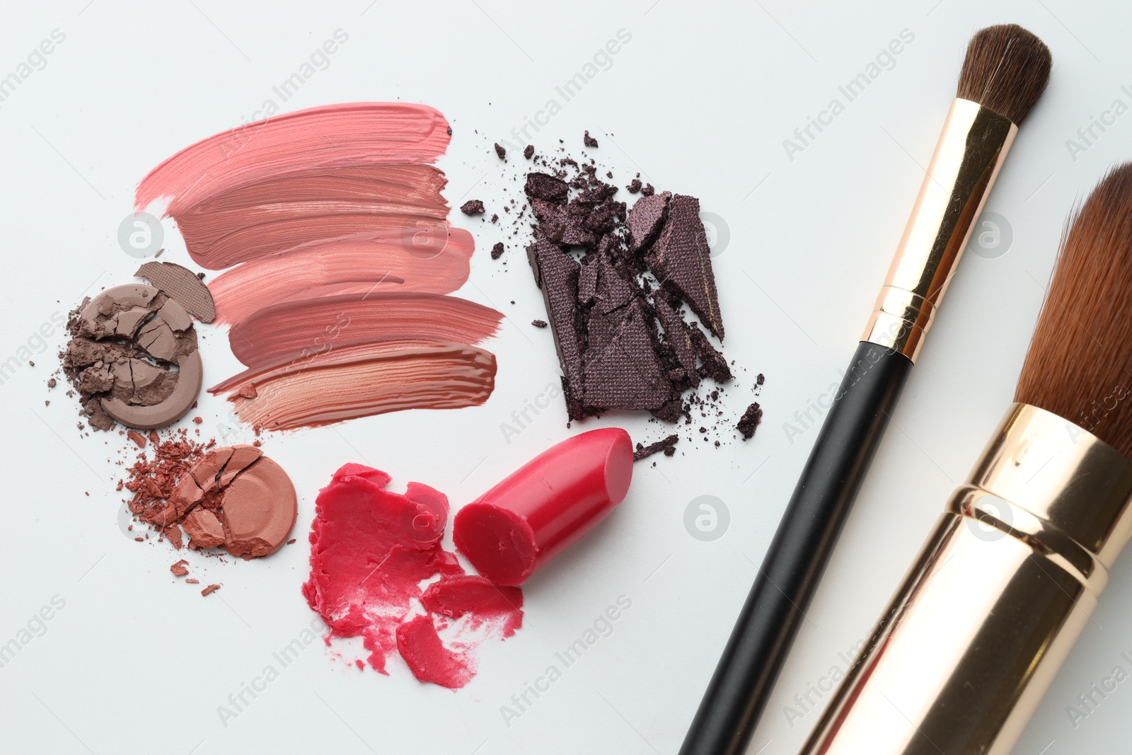 Photo of Different cosmetic products and makeup brushes on white background, flat lay