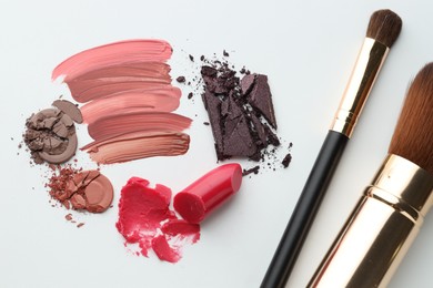 Photo of Different cosmetic products and makeup brushes on white background, flat lay