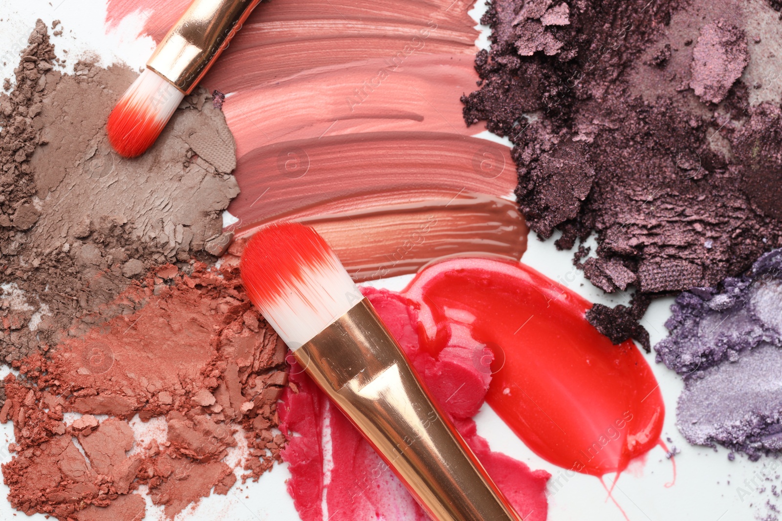 Different cosmetic products and makeup brushes on white background, flat lay Photo of Different cosmetic products and makeup brushes on white background, flat lay