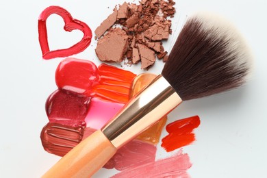 Photo of Different cosmetic products and makeup brush on white background, flat lay