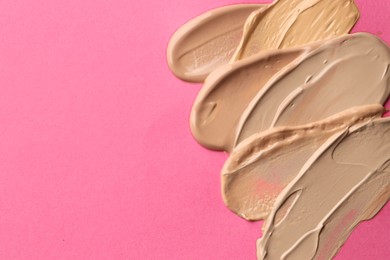 Photo of Colorful skin foundations on magenta background, flat lay. Space for text