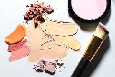 Photo of Different cosmetic products and makeup brush on white background, flat lay