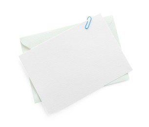Photo of Blank invitation card and envelope isolated on white, top view. Space for design